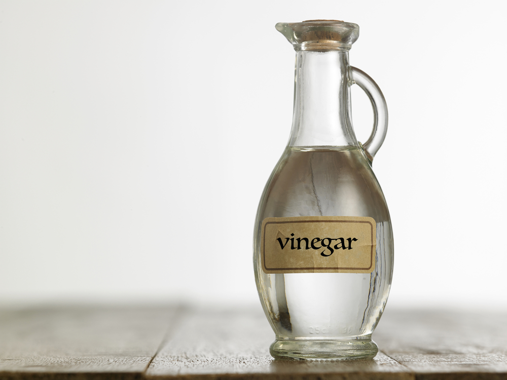 white vinegar on wooden table