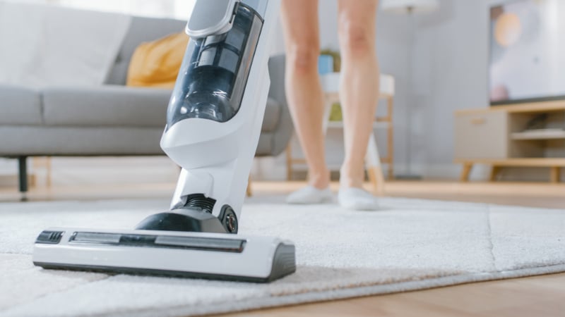 woman vacuum cleaning the carpet